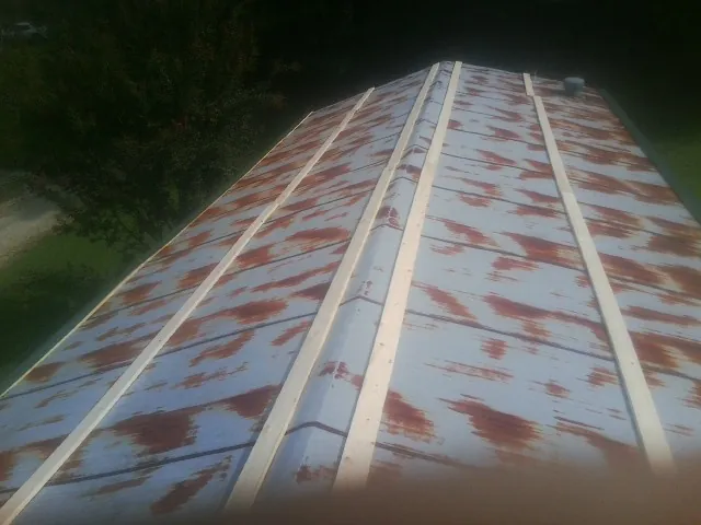 Rusted metal roof panels with new wood purlins before replacement — Storm Damage Roof Repair in Morristown by Roofing Brothers