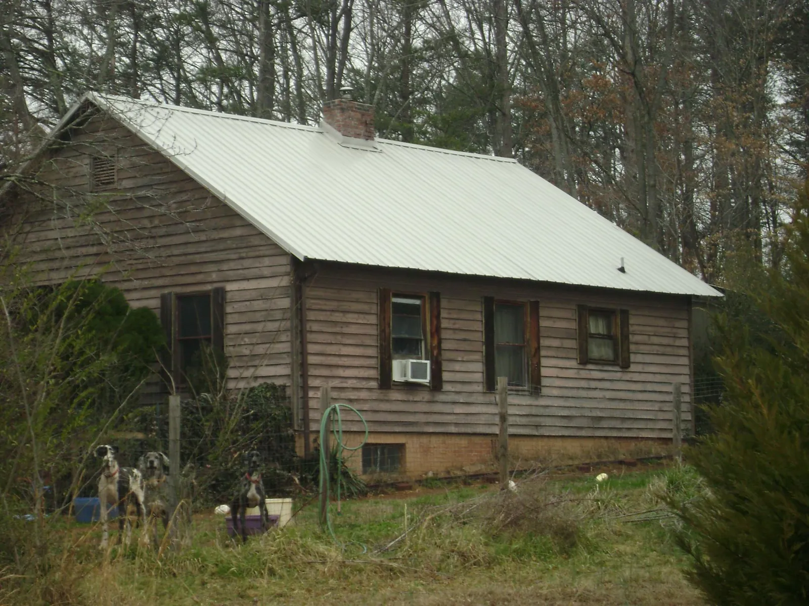 White metal roof on an old wood sided farmhouse, from a Asphalt Shingle Roof Repair job in Morristown